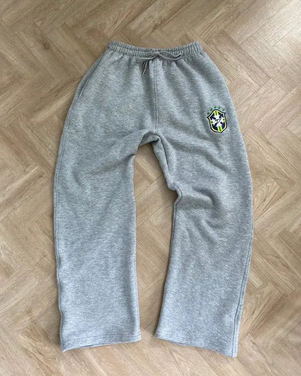 Grey BRASIL drawstring joggers with a crest detail laid flat