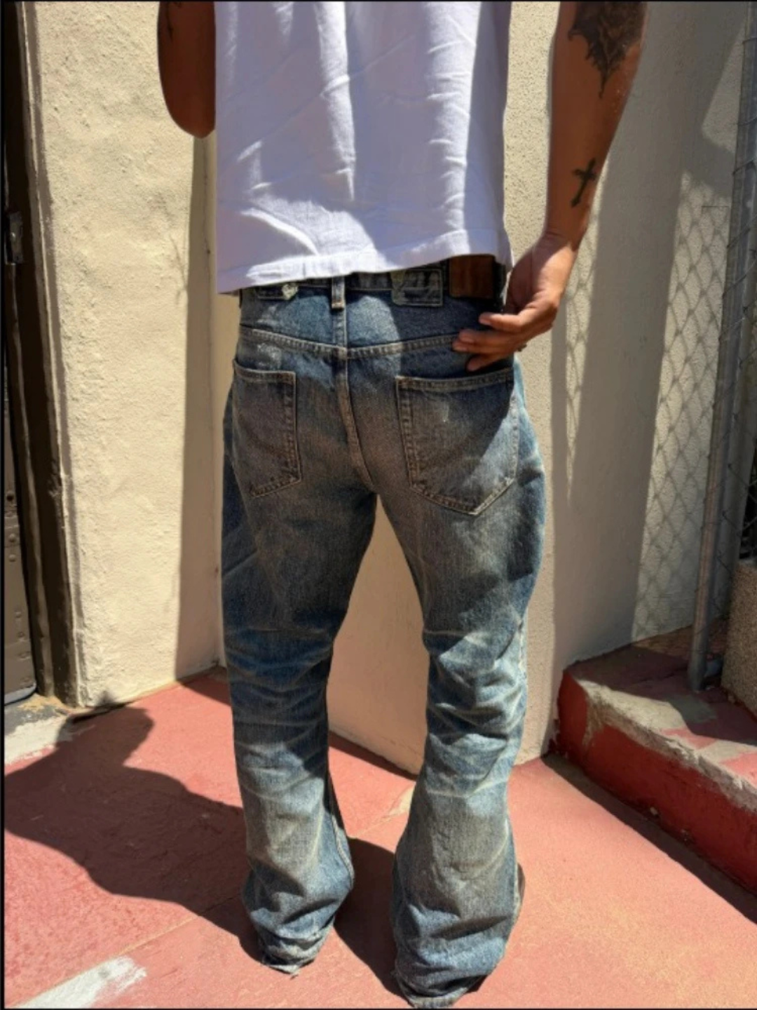 WORN — FLARED JEANS — blue jeans on model, rear fit view
