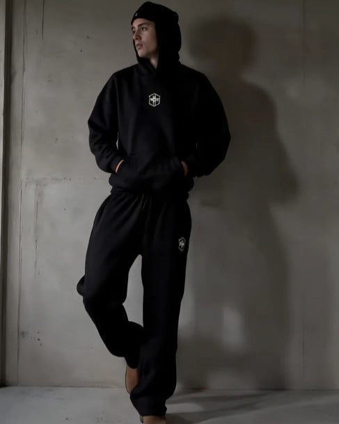 Black BRASIL hoodie and joggers worn against a grey wall