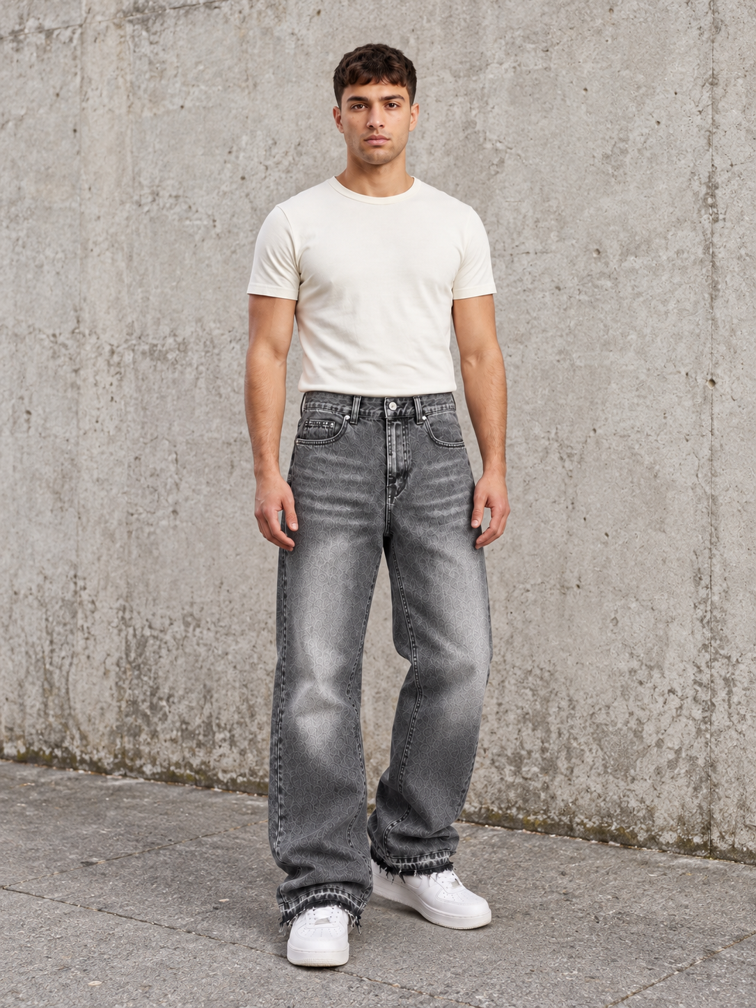 Off Culture Fade Dark Gray jeans — full front lifestyle view beside a concrete wall